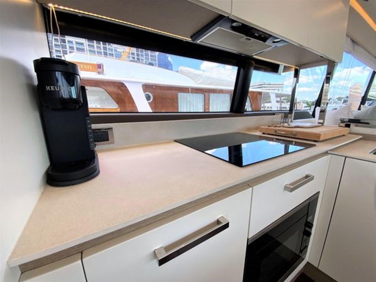 a black coffee maker on a white counter aboard 2016 PRESTIGE 680 FLY Yacht for Sale