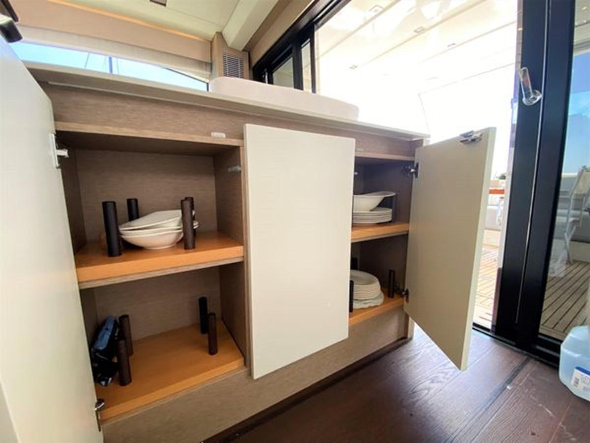 a room with a cabinet and shelves aboard 2016 PRESTIGE 680 FLY Yacht for Sale