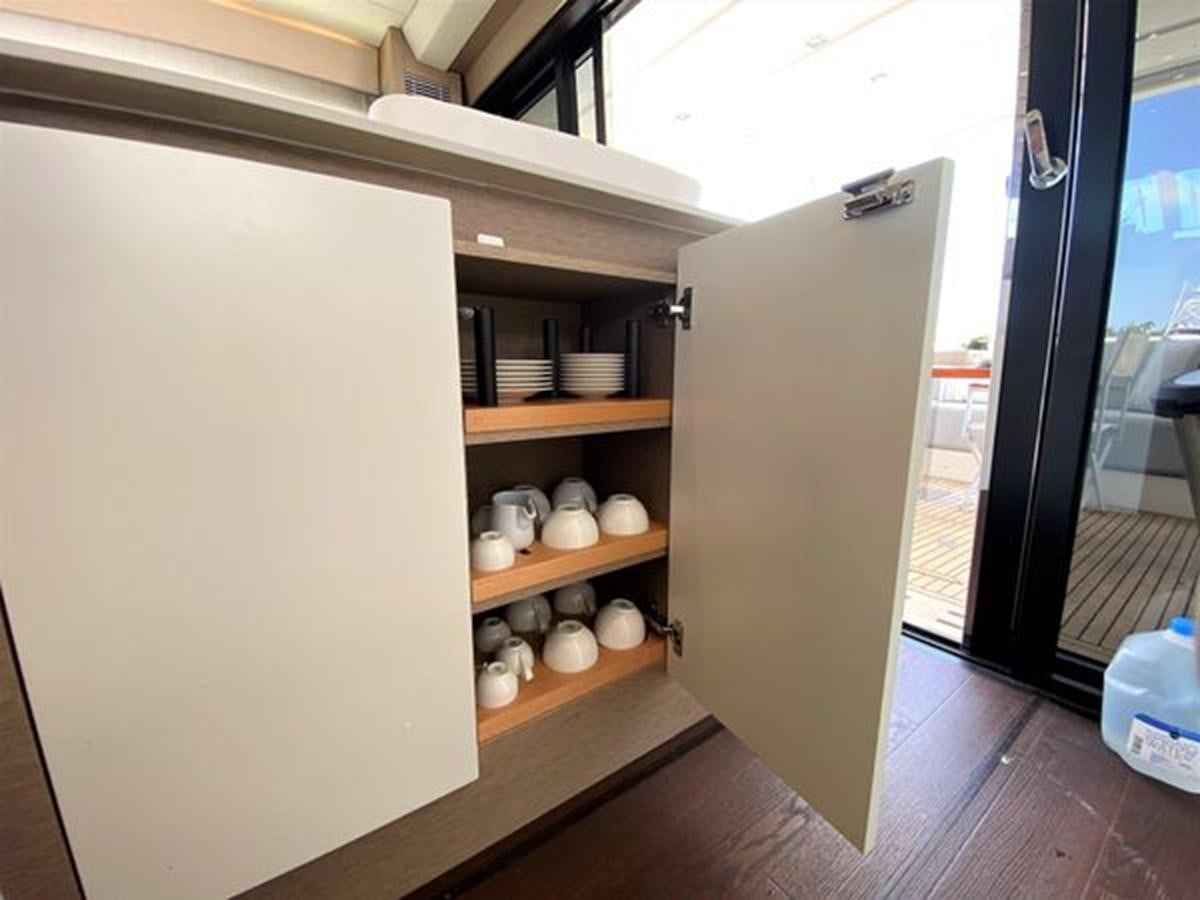 a refrigerator next to a door aboard 2016 PRESTIGE 680 FLY Yacht for Sale