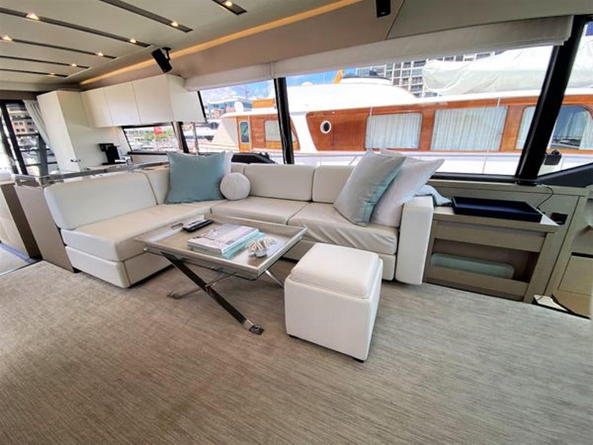 a living room with a couch and a coffee table aboard 2016 PRESTIGE 680 FLY Yacht for Sale