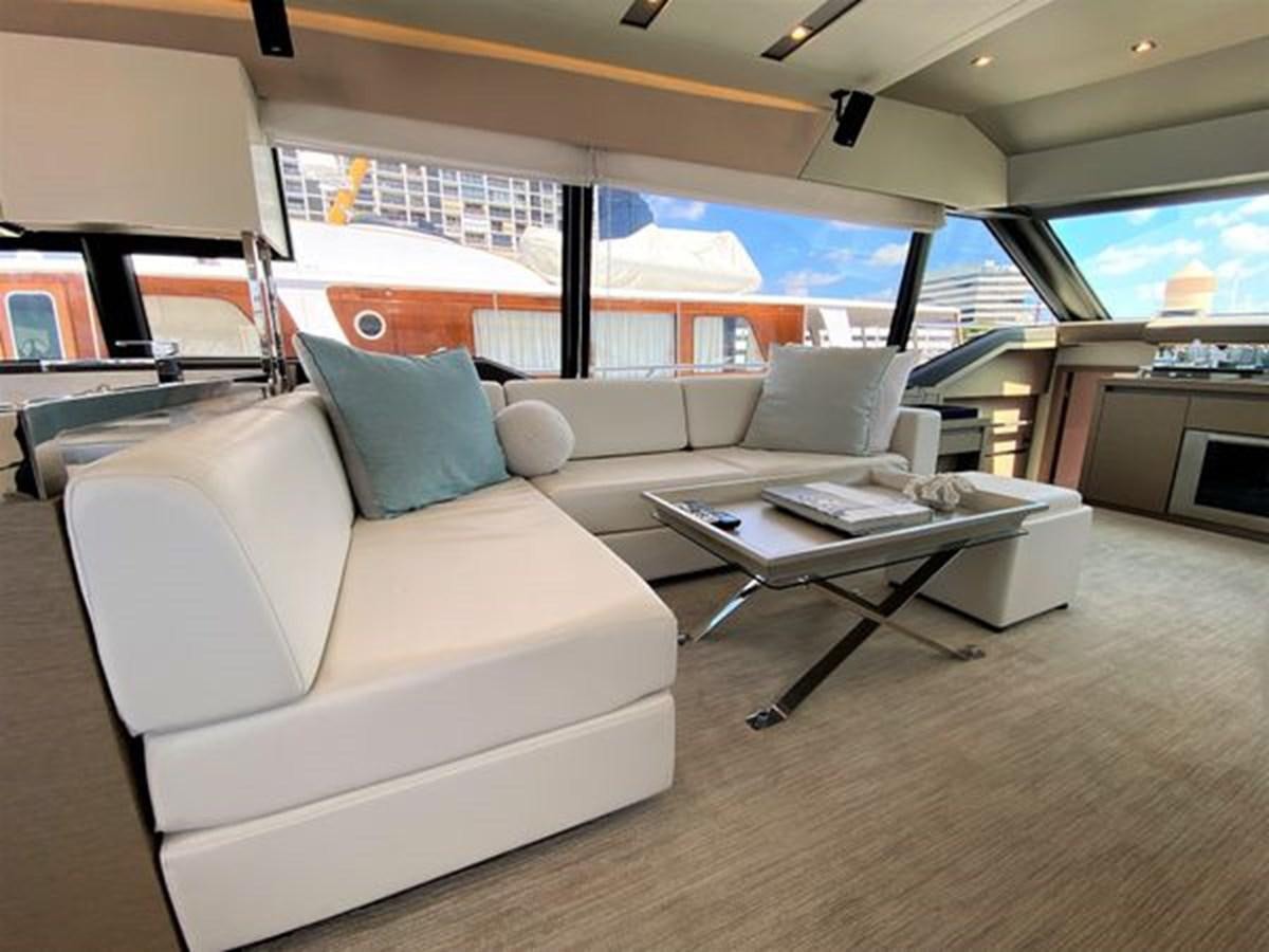 a living room with a couch and a table aboard 2016 PRESTIGE 680 FLY Yacht for Sale