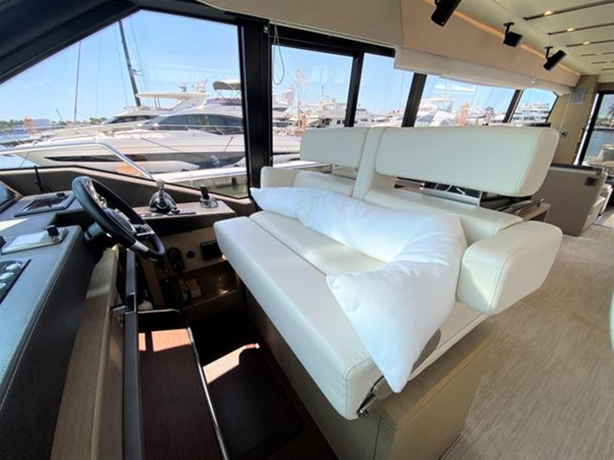 a vehicle with a couch and a table in the back aboard 2016 PRESTIGE 680 FLY Yacht for Sale