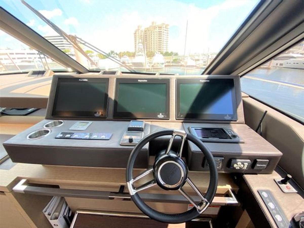a desk with a computer and monitors aboard 2016 PRESTIGE 680 FLY Yacht for Sale