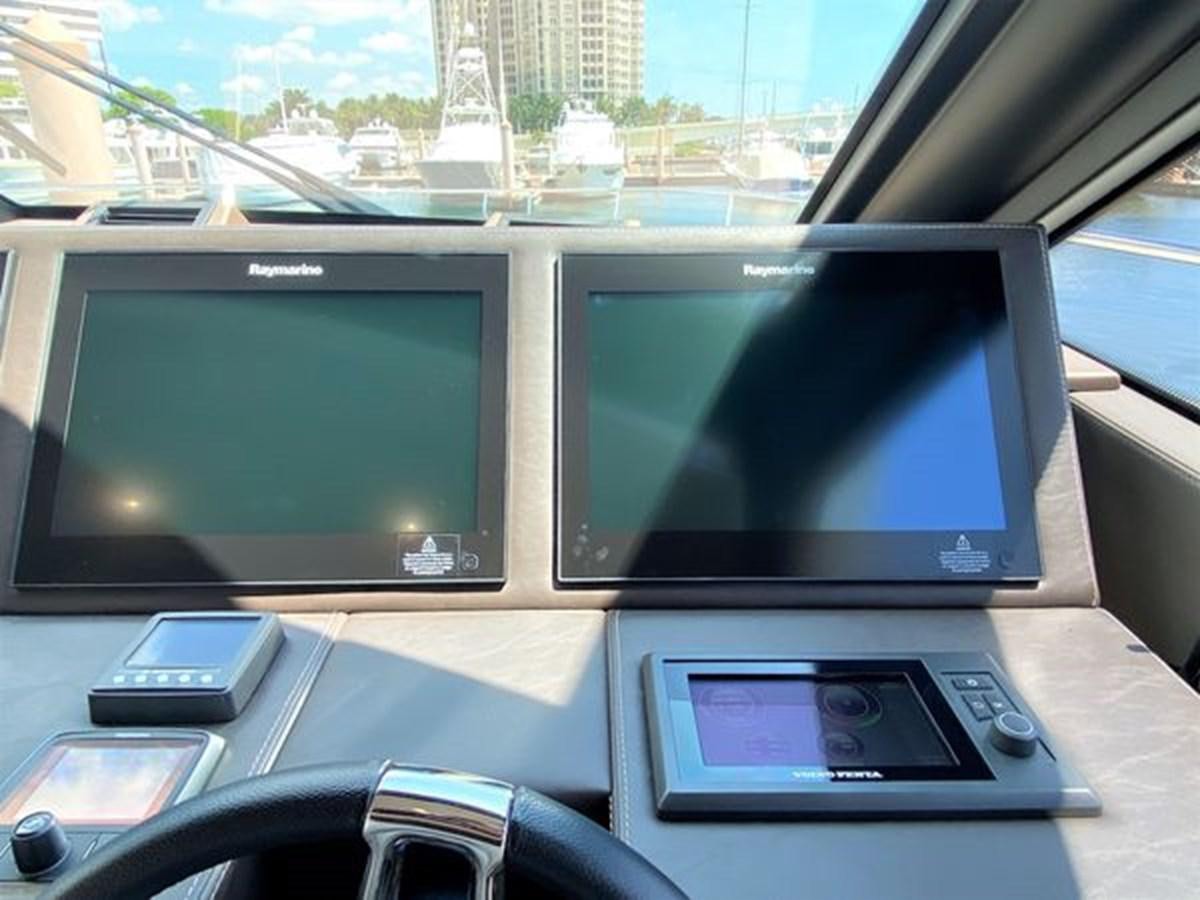a couple of monitors on a table aboard 2016 PRESTIGE 680 FLY Yacht for Sale