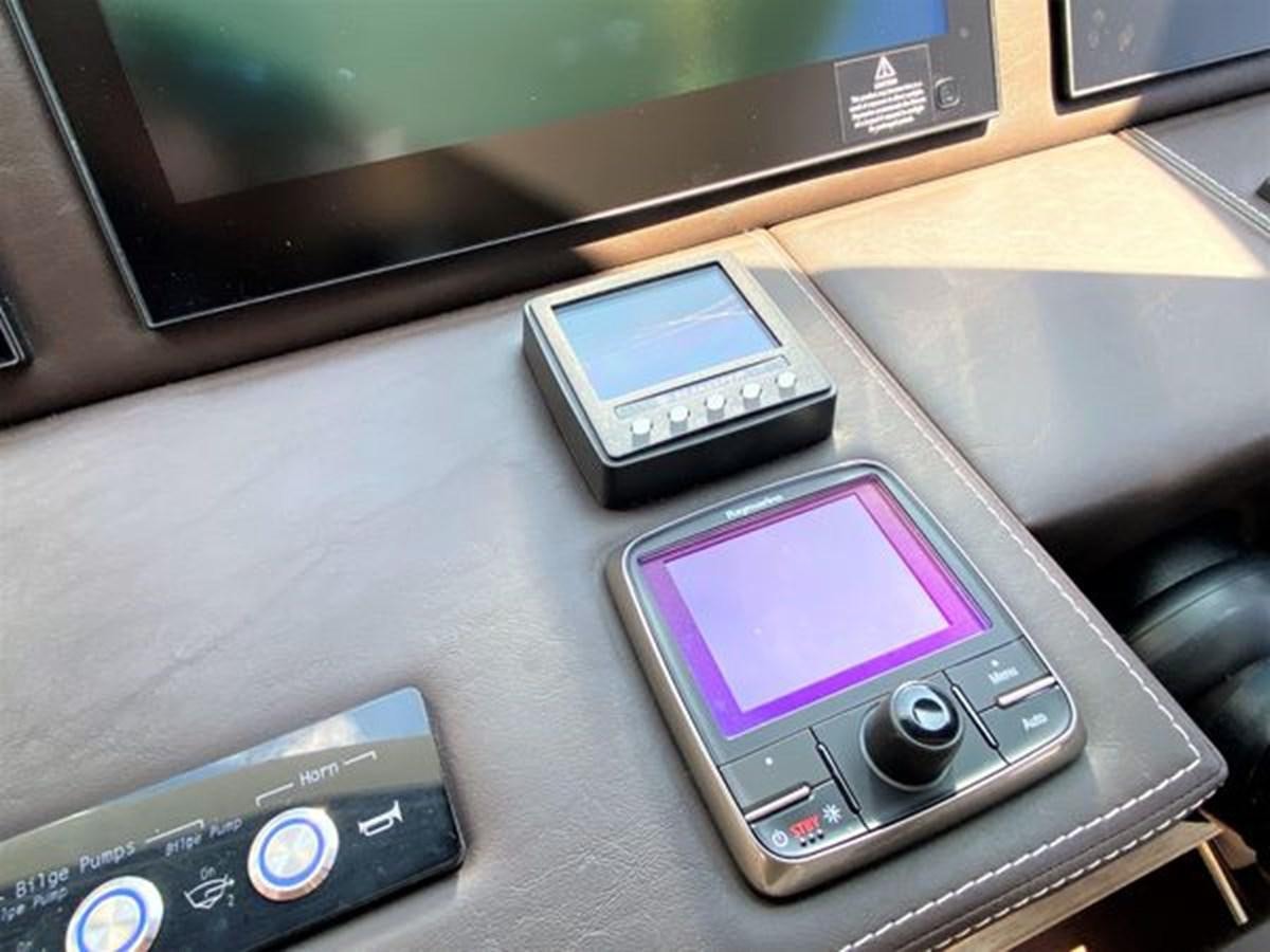 a group of cell phones on a table aboard 2016 PRESTIGE 680 FLY Yacht for Sale