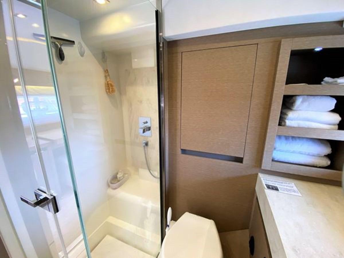 a bathroom with a glass shower aboard 2016 PRESTIGE 680 FLY Yacht for Sale