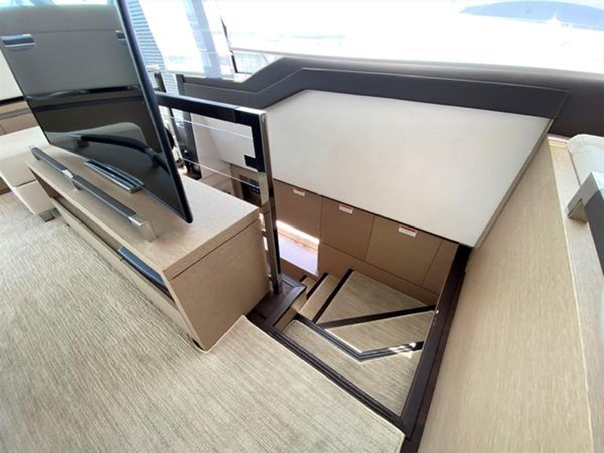 a room with a desk and chairs aboard 2016 PRESTIGE 680 FLY Yacht for Sale