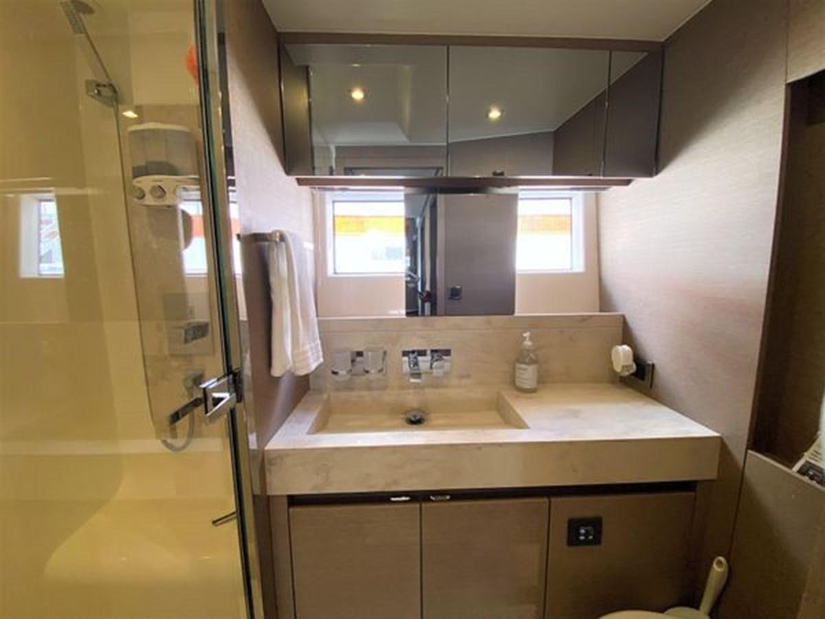 a bathroom with a glass shower door aboard 2016 PRESTIGE 680 FLY Yacht for Sale