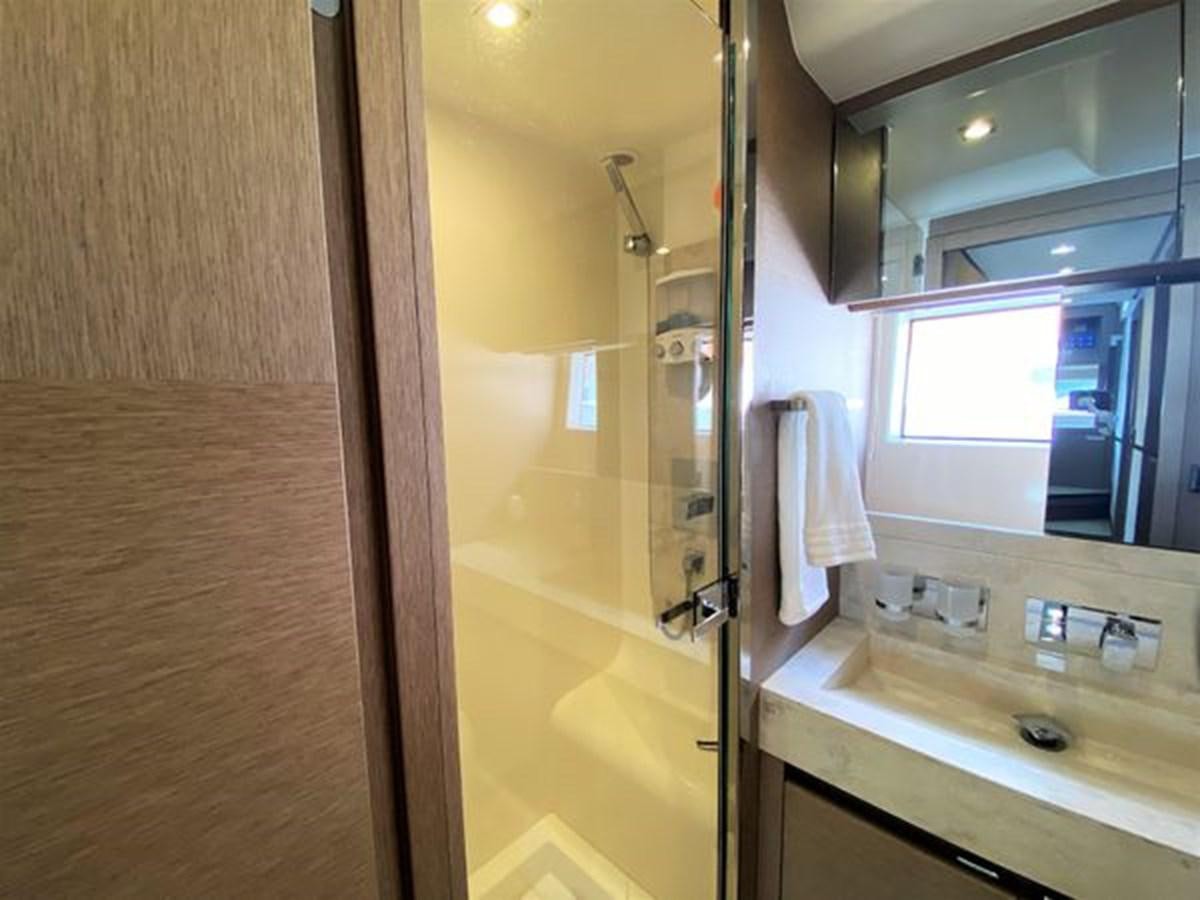 a bathroom with a glass shower aboard 2016 PRESTIGE 680 FLY Yacht for Sale
