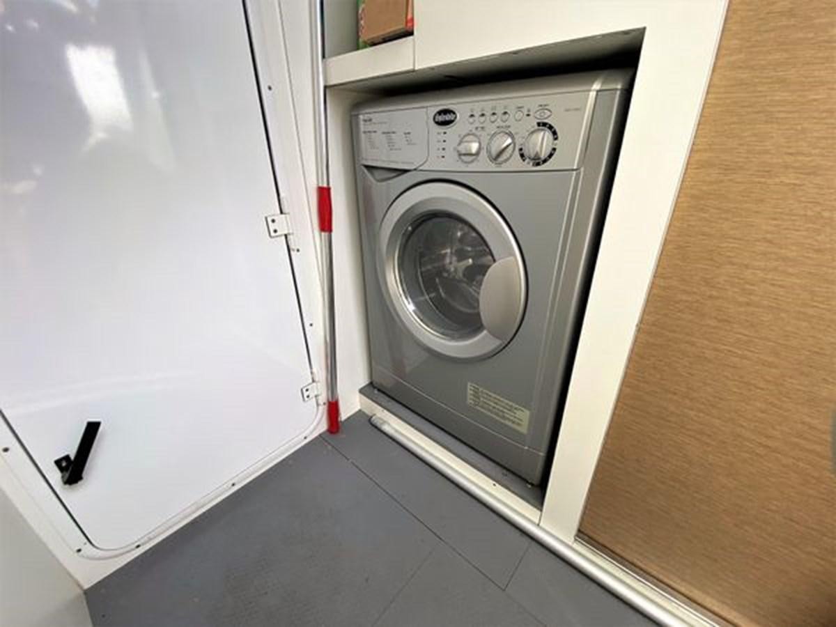 a white washing machine aboard 2016 PRESTIGE 680 FLY Yacht for Sale