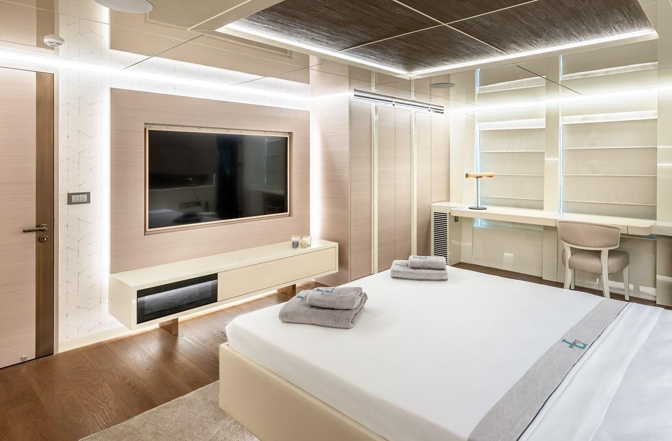 a room with a large flat screen television and a table aboard PROJECT 105 Yacht for Sale