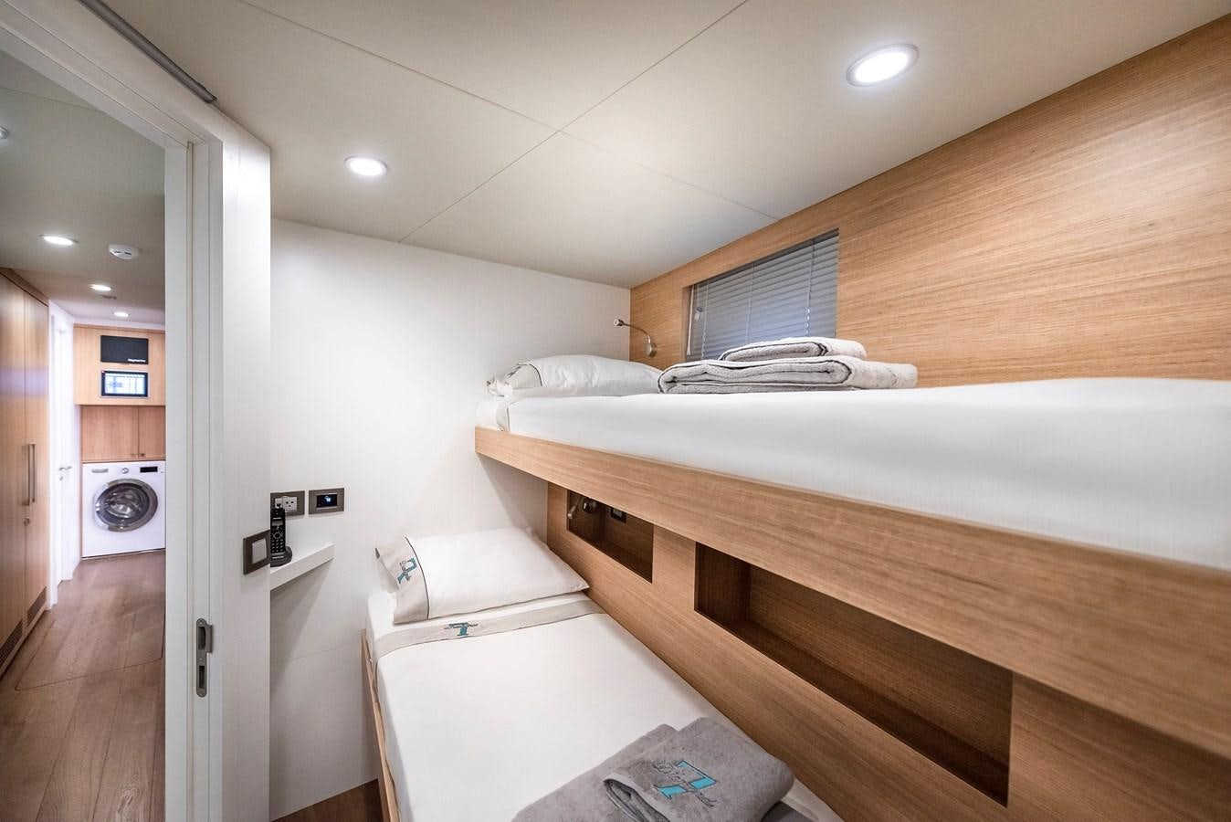 a bedroom with a wood floor aboard PROJECT 105 Yacht for Sale