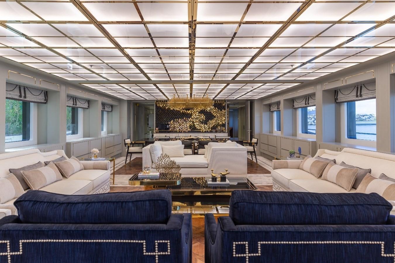 a room with couches and a table aboard N.M.N Yacht for Sale