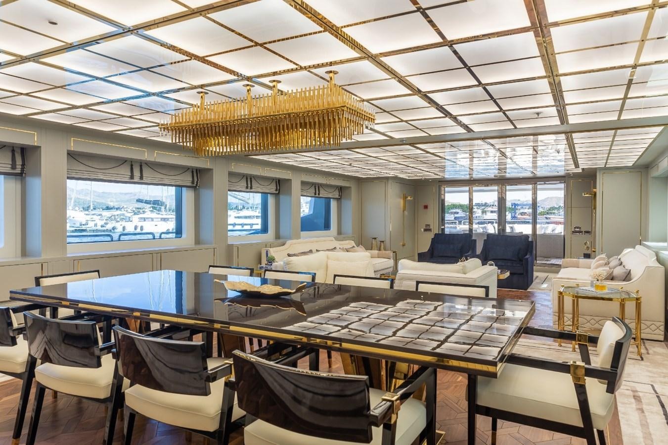 a room with a table chairs and a large screen aboard N.M.N Yacht for Sale