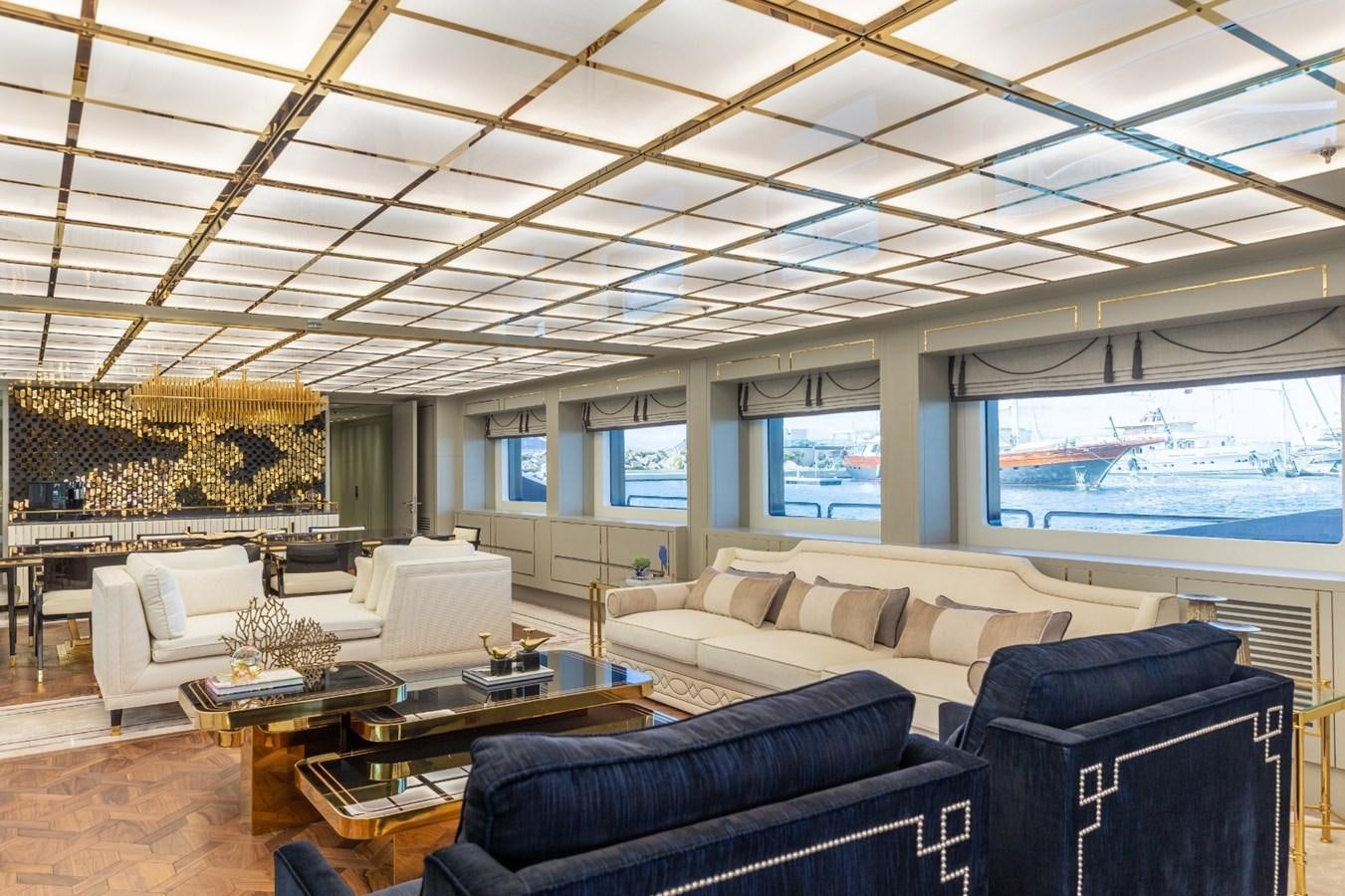 a room with couches and a table aboard N.M.N Yacht for Sale