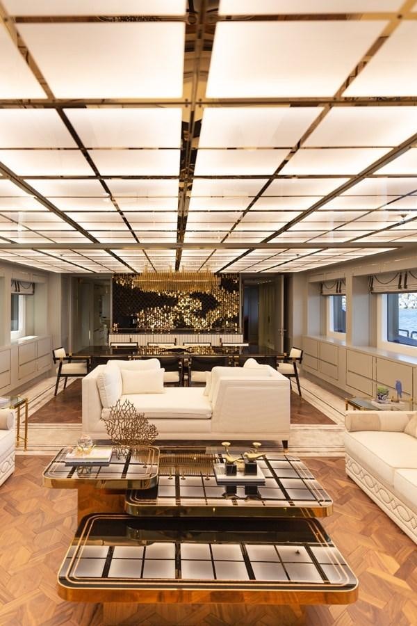 a modern living room with a large glass ceiling aboard N.M.N Yacht for Sale