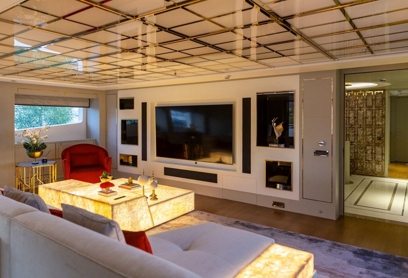 a living room with a large screen aboard N.M.N Yacht for Sale