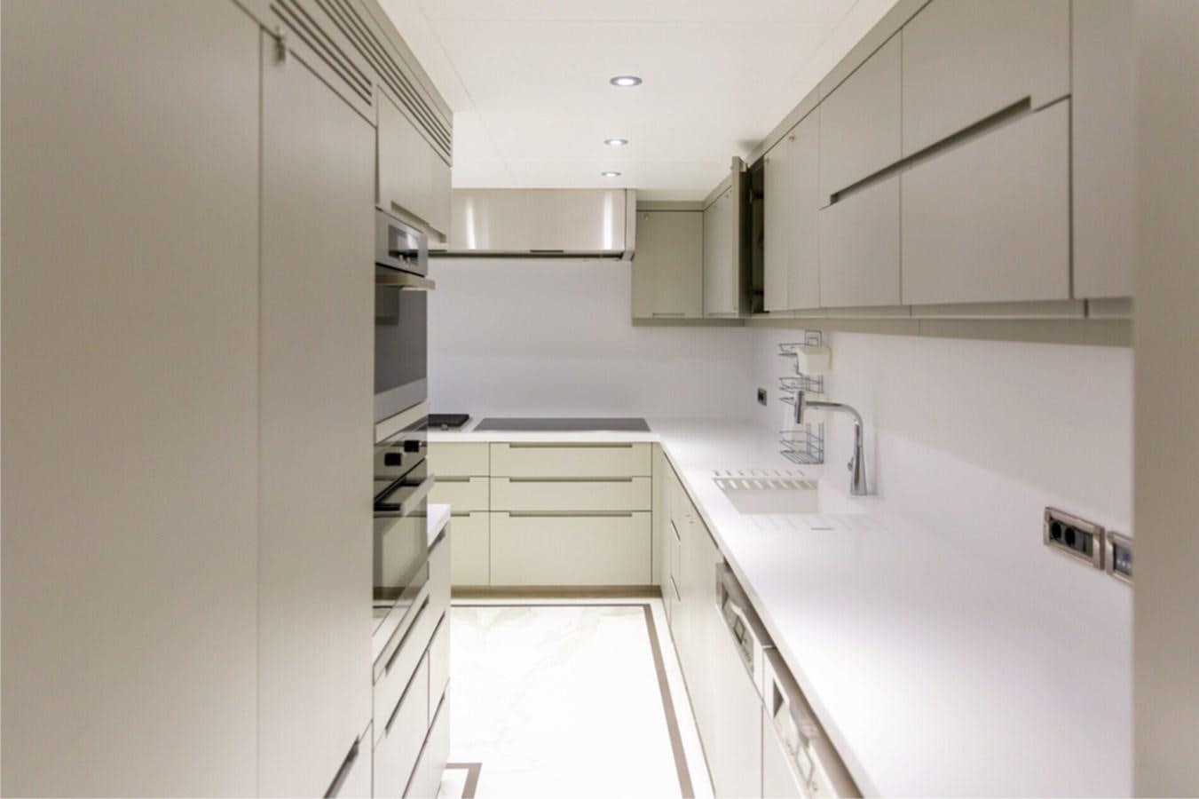 a kitchen with white cabinets aboard N.M.N Yacht for Sale