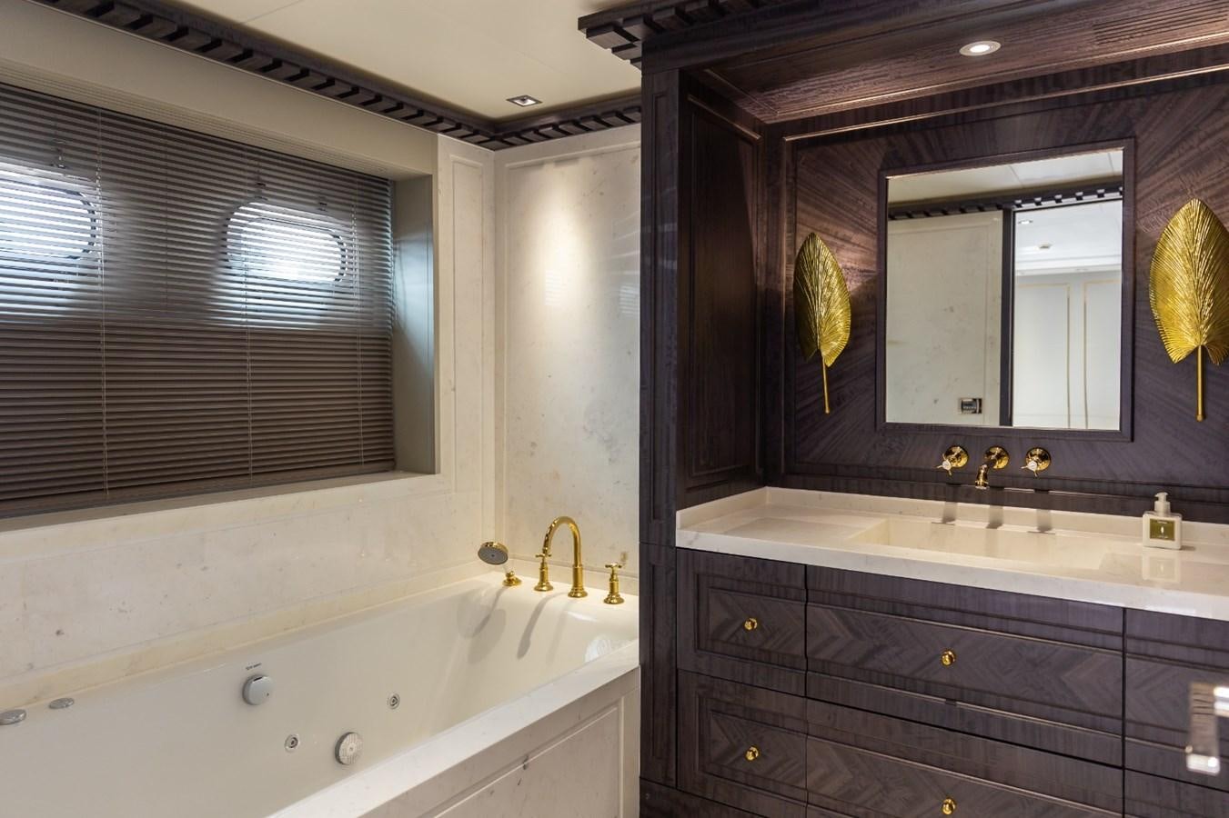 a bathroom with a bathtub and a sink aboard N.M.N Yacht for Sale