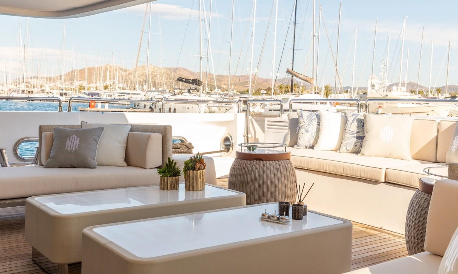 a large white table with chairs and a large white table with plants on it aboard N.M.N Yacht for Sale