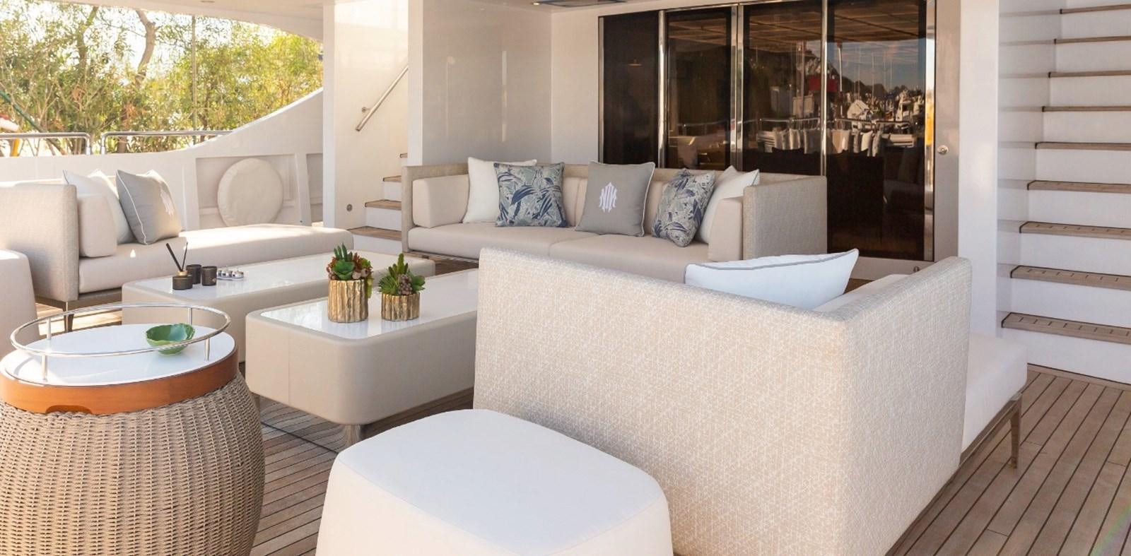 a living room with a couch and a table aboard N.M.N Yacht for Sale