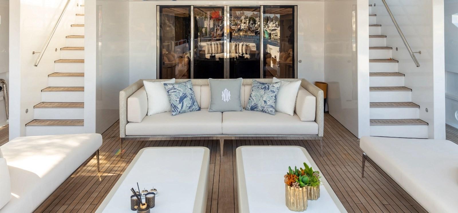 a living room with a white couch and a table aboard N.M.N Yacht for Sale