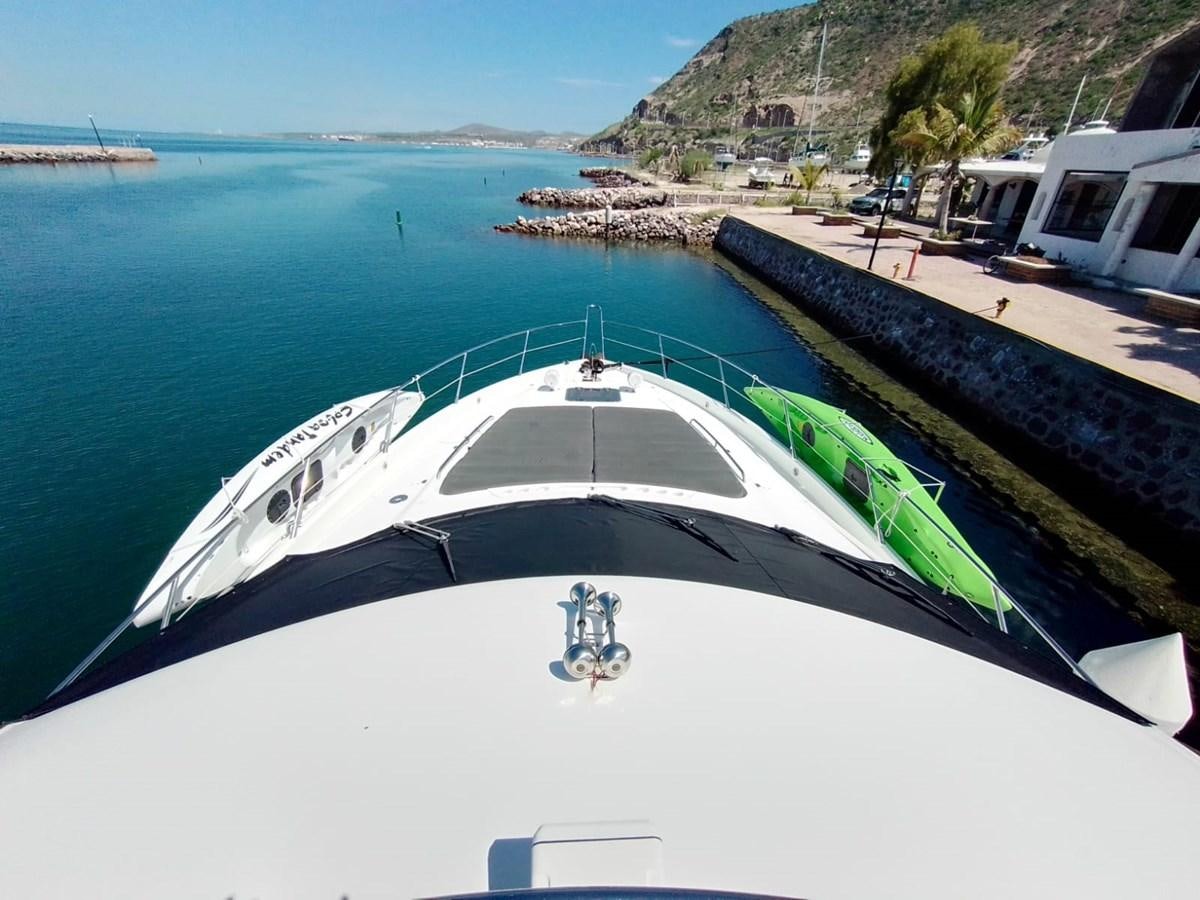 a white boat in a body of water aboard CAPRICHO Yacht for Sale