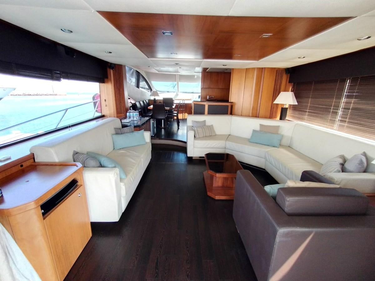 a living room with a large window aboard CAPRICHO Yacht for Sale
