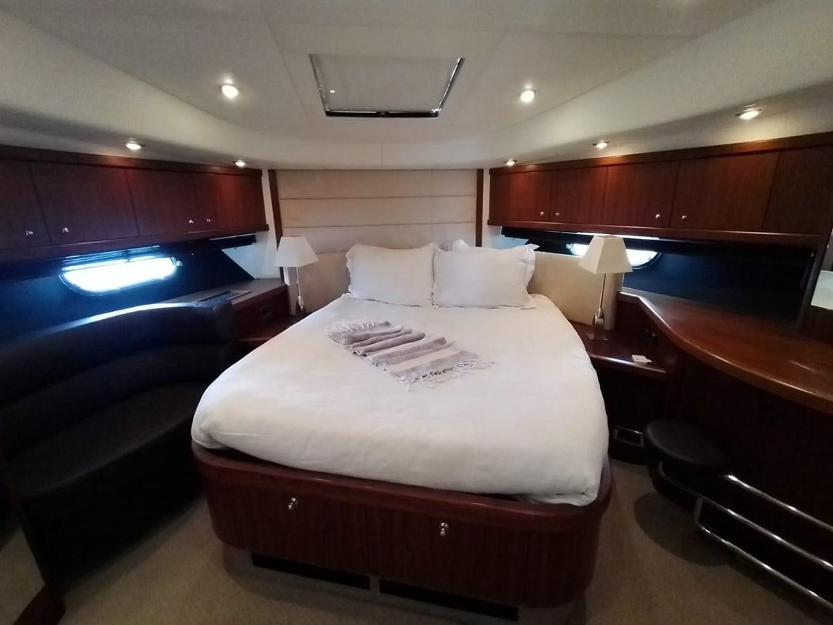 a room with a bed and a window aboard CAPRICHO Yacht for Sale