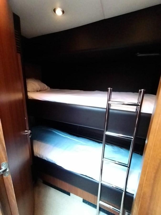 a bed with a blue sheet aboard CAPRICHO Yacht for Sale