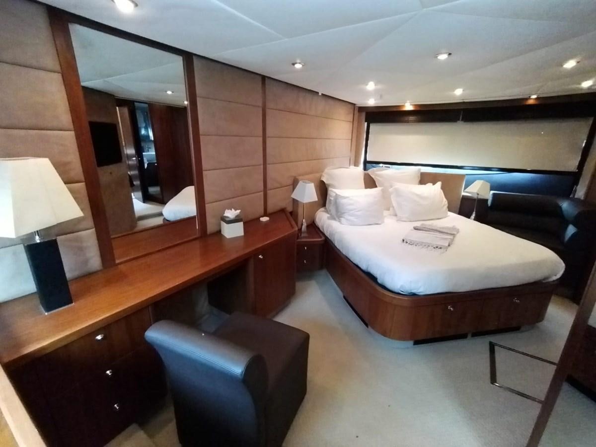 a hotel room with a bed and a desk aboard CAPRICHO Yacht for Sale
