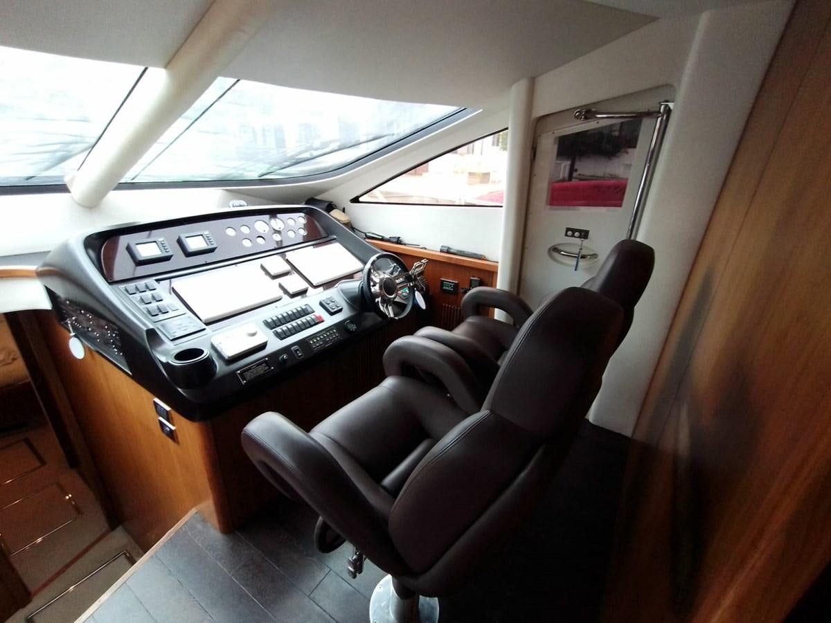 a car seat with a seat and steering wheel aboard CAPRICHO Yacht for Sale