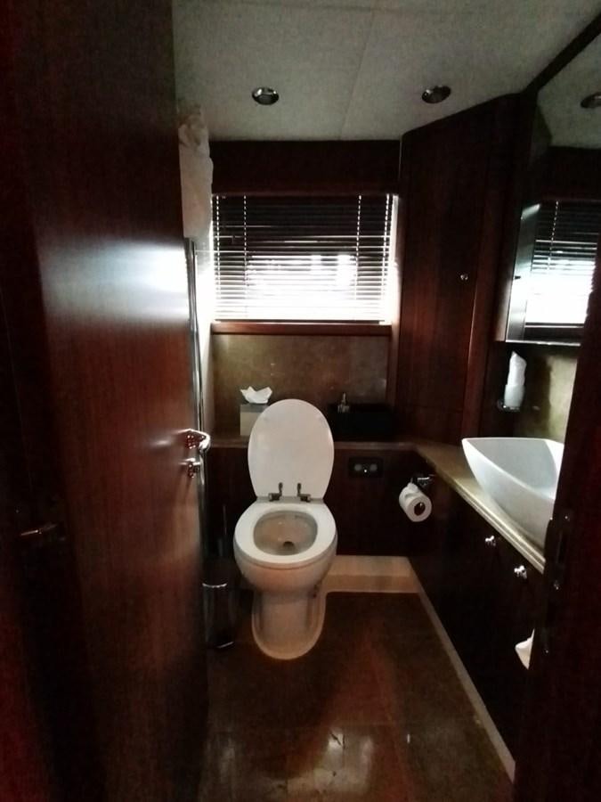a bathroom with a toilet and sink aboard CAPRICHO Yacht for Sale