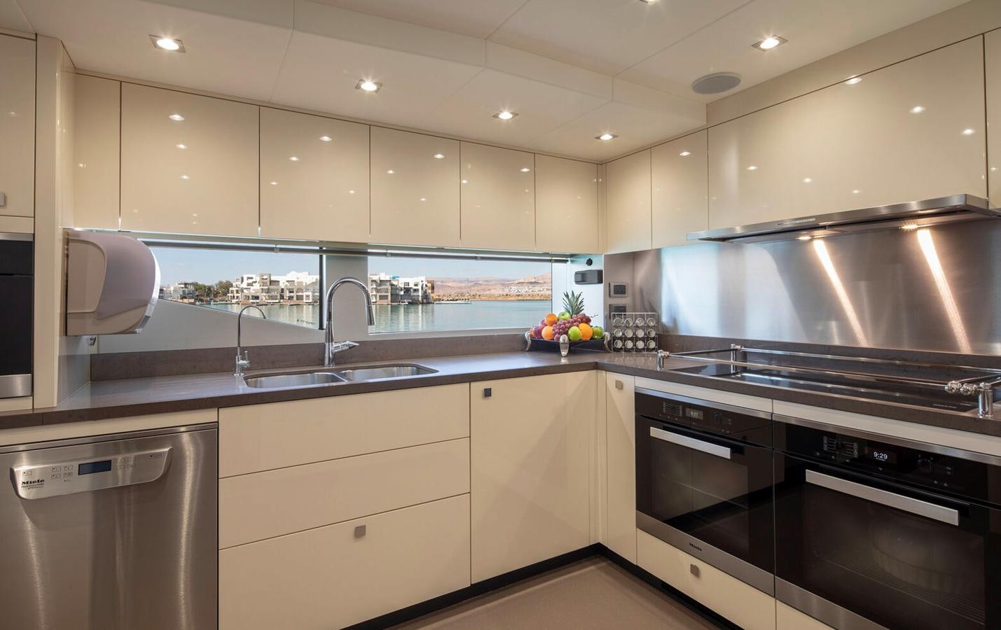 a kitchen with white cabinets aboard 2018 SUNSEEKER 116 Yacht for Sale