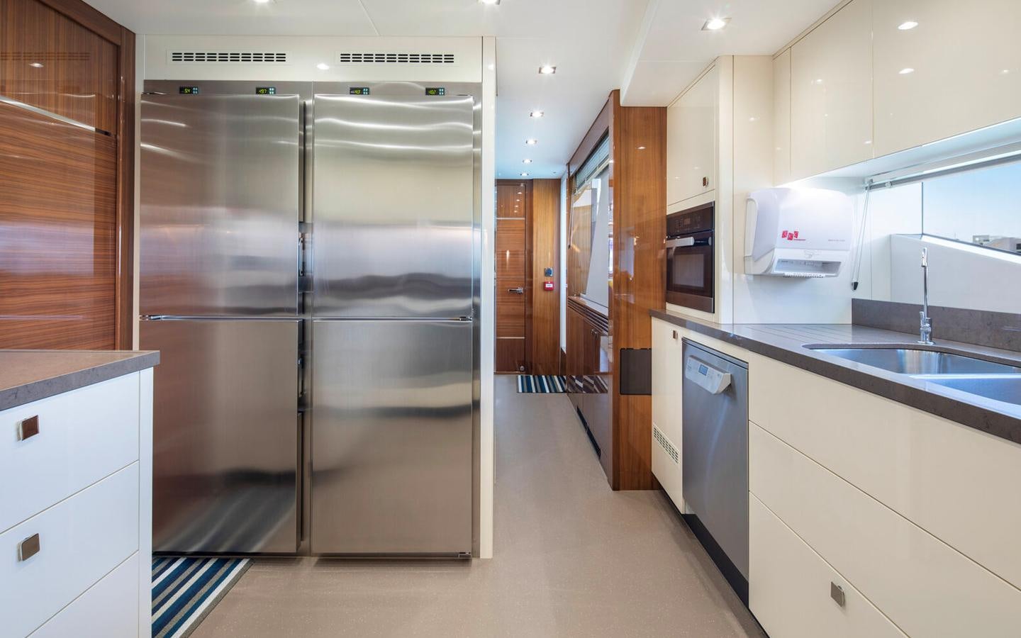 a large kitchen with stainless steel appliances aboard 2018 SUNSEEKER 116 Yacht for Sale