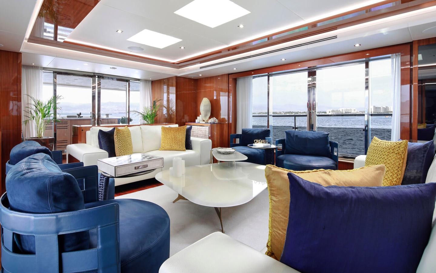 a living room with a large window aboard 2018 SUNSEEKER 116 Yacht for Sale