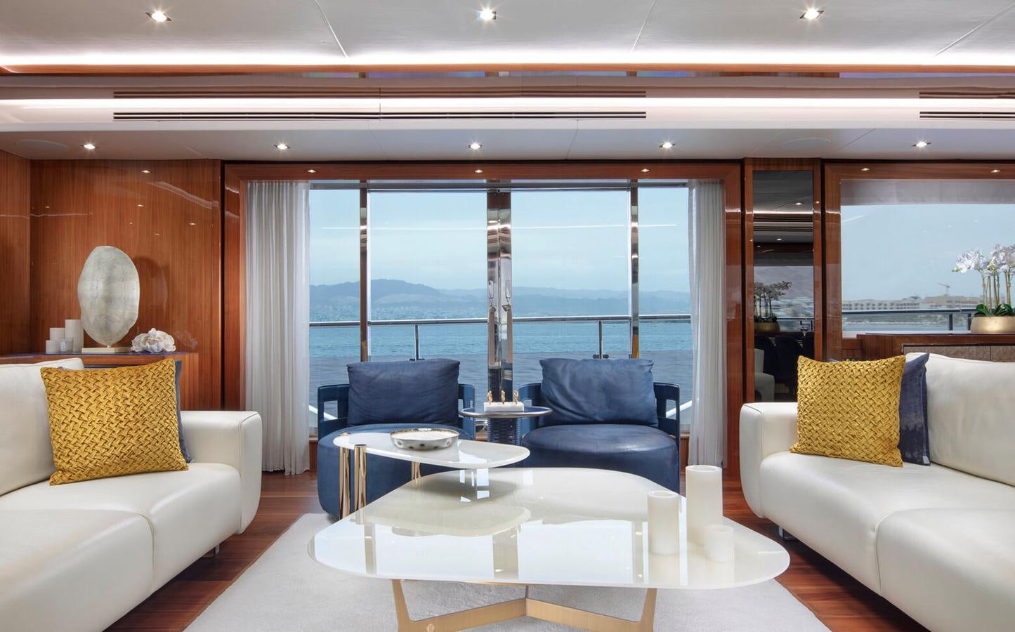 a living room with a large window aboard 2018 SUNSEEKER 116 Yacht for Sale