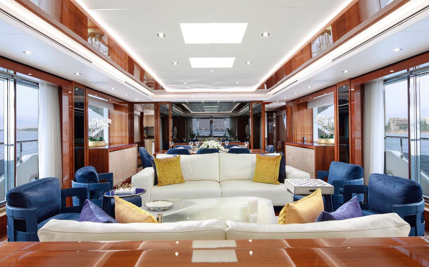a living room with a couch and a large window aboard 2018 SUNSEEKER 116 Yacht for Sale