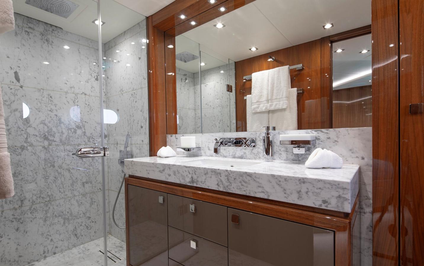 a bathroom with a large mirror aboard 2018 SUNSEEKER 116 Yacht for Sale