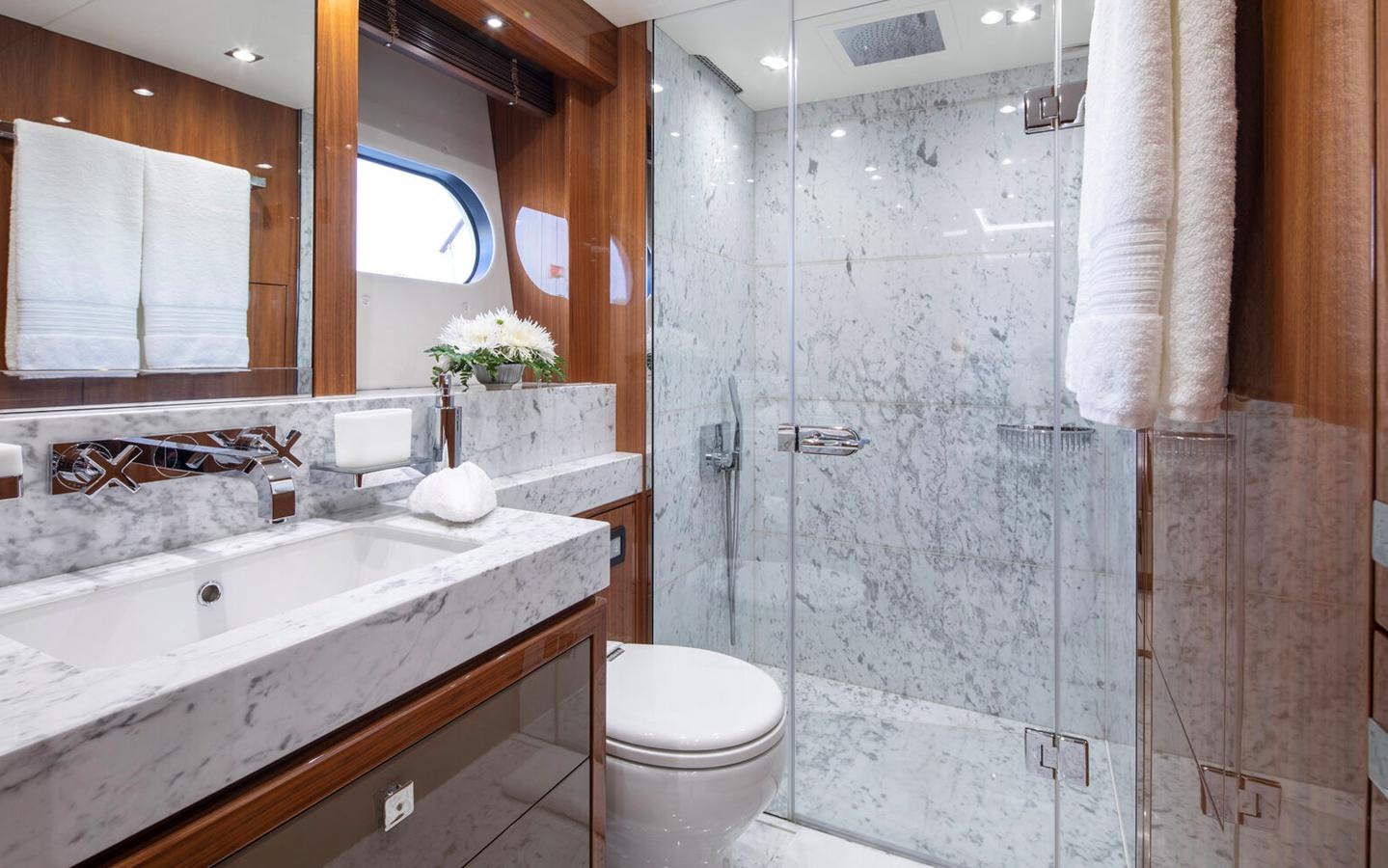 a bathroom with a sink toilet and a bathtub aboard 2018 SUNSEEKER 116 Yacht for Sale