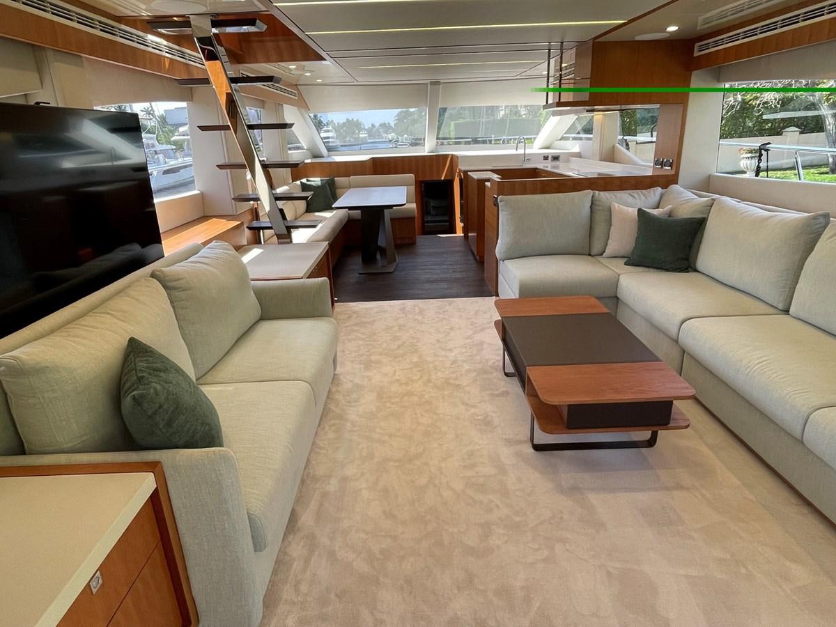 a living room with a couch and a tv aboard JOHNSON 83 SKYLOUNGE Yacht for Sale
