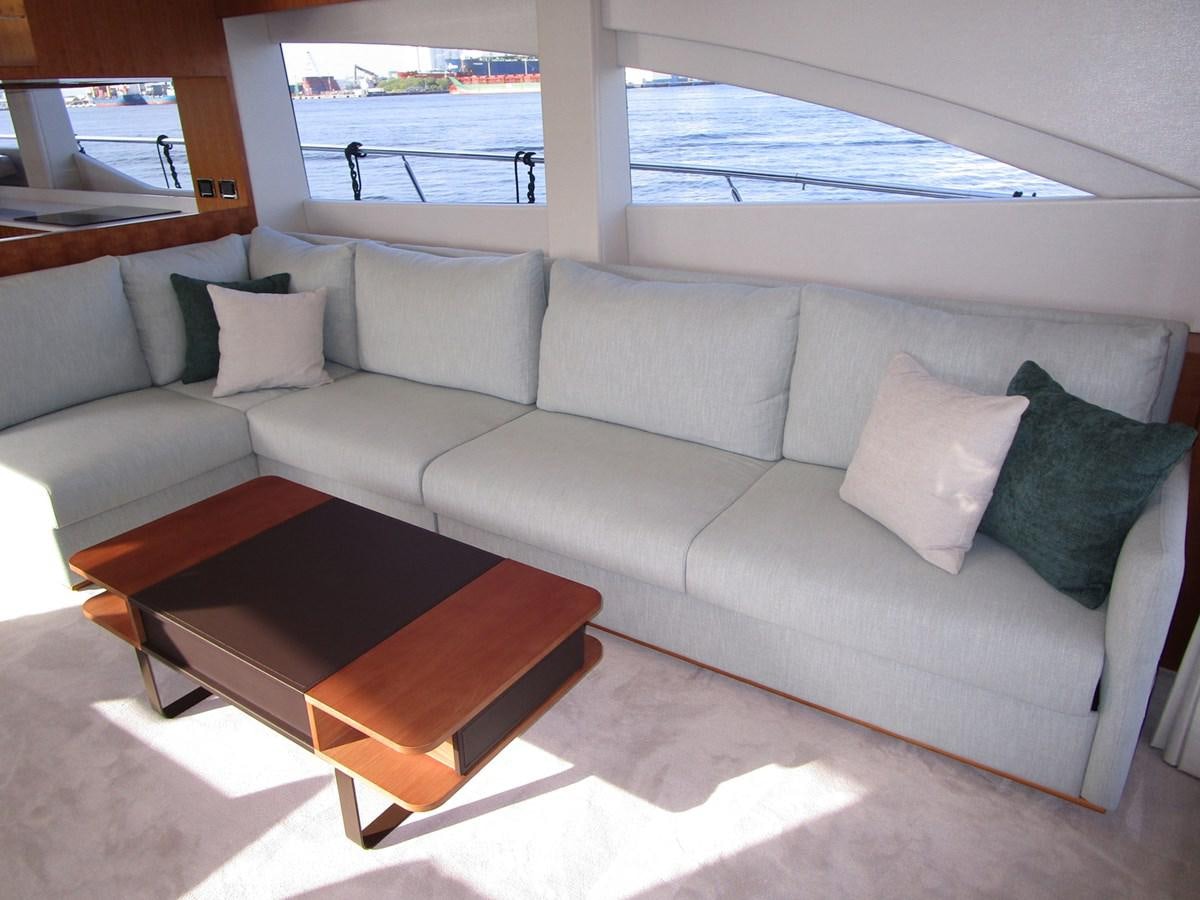 a couch with pillows on it aboard JOHNSON 83 SKYLOUNGE Yacht for Sale