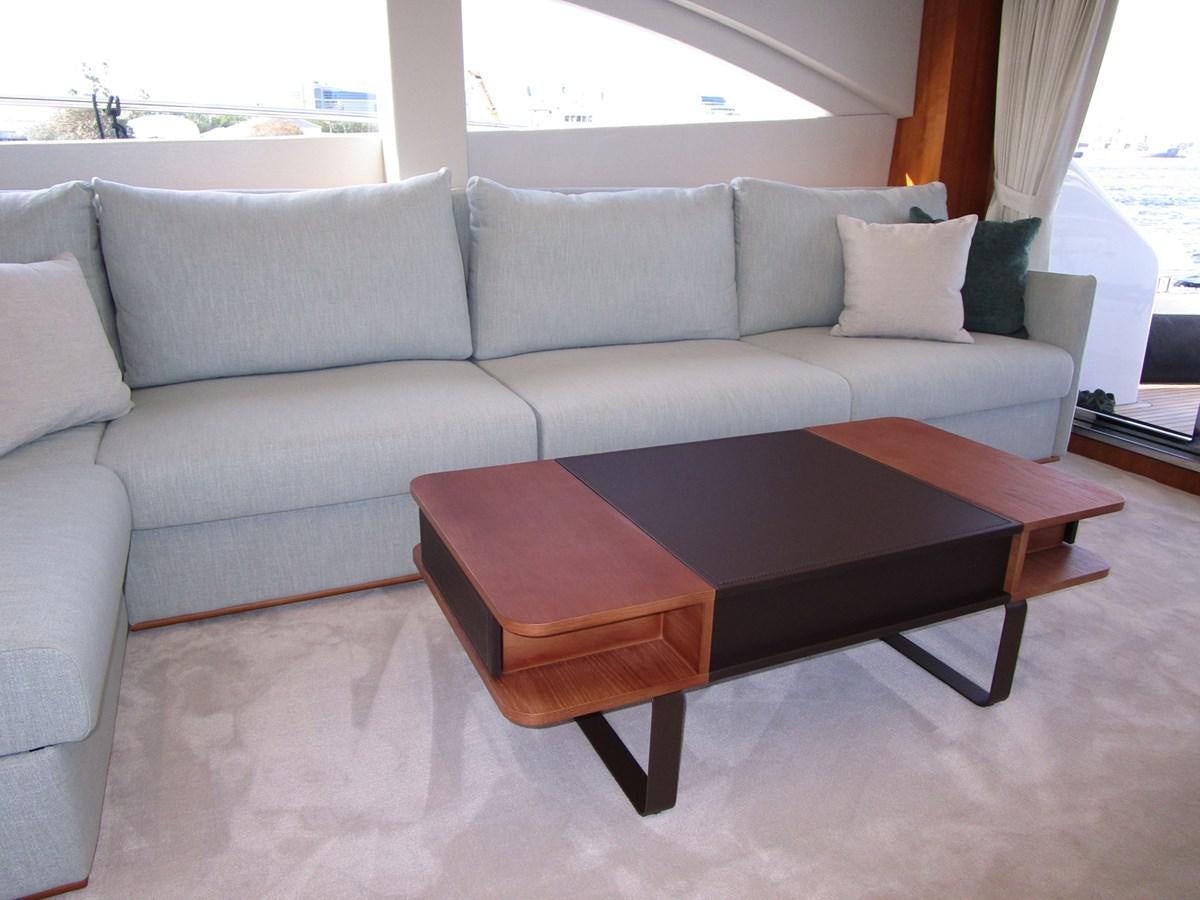 a couch with a coffee table aboard JOHNSON 83 SKYLOUNGE Yacht for Sale