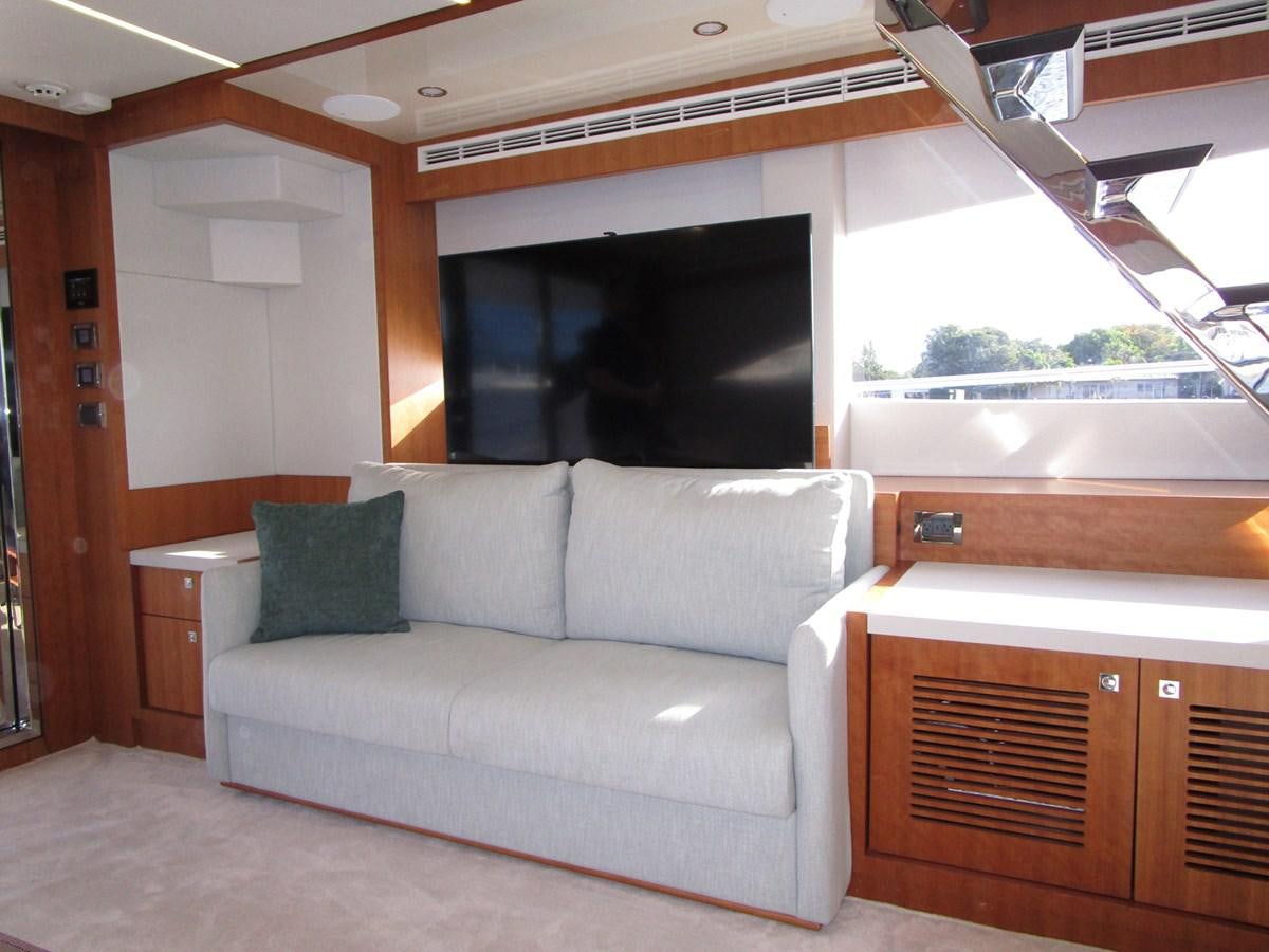 a living room with a couch aboard JOHNSON 83 SKYLOUNGE Yacht for Sale