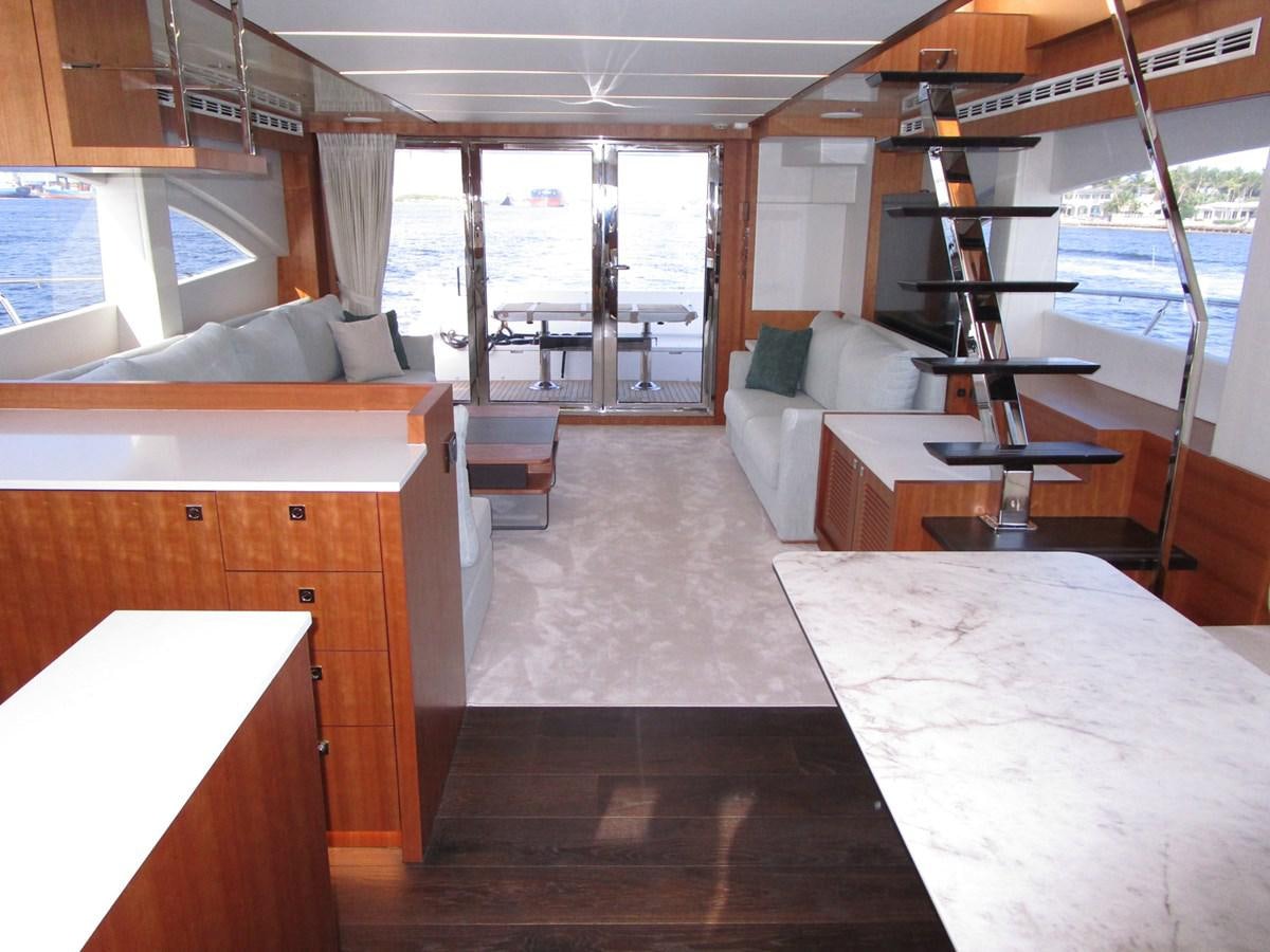 a room with a bed and a desk aboard JOHNSON 83 SKYLOUNGE Yacht for Sale