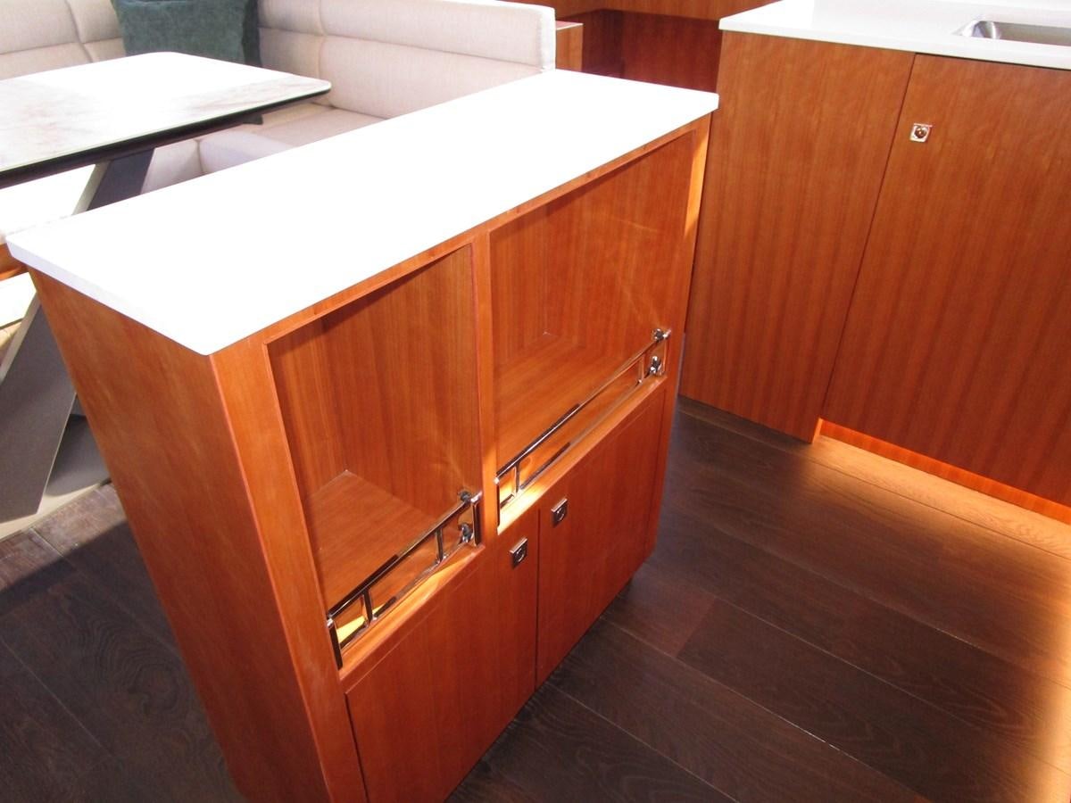 a wooden cabinet with a drawer aboard JOHNSON 83 SKYLOUNGE Yacht for Sale