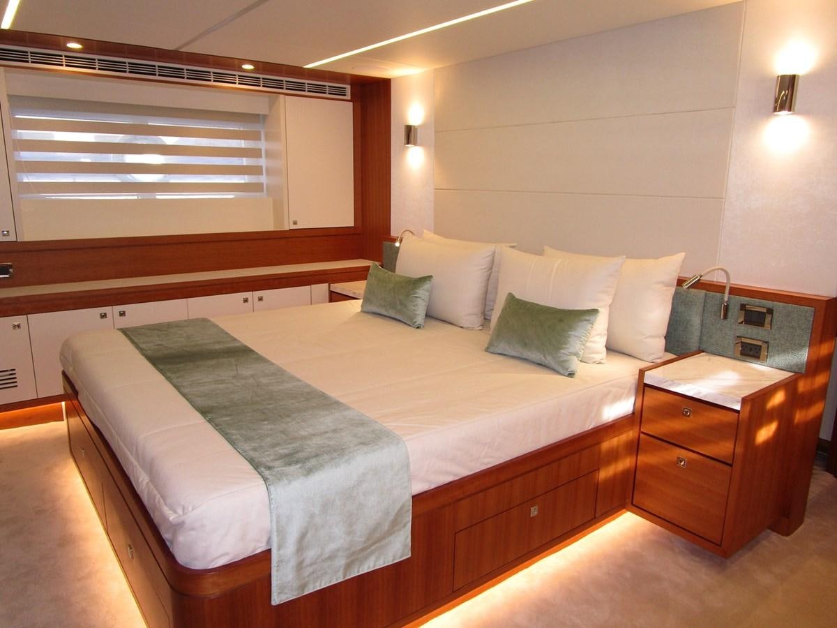 a bed with a white comforter aboard JOHNSON 83 SKYLOUNGE Yacht for Sale