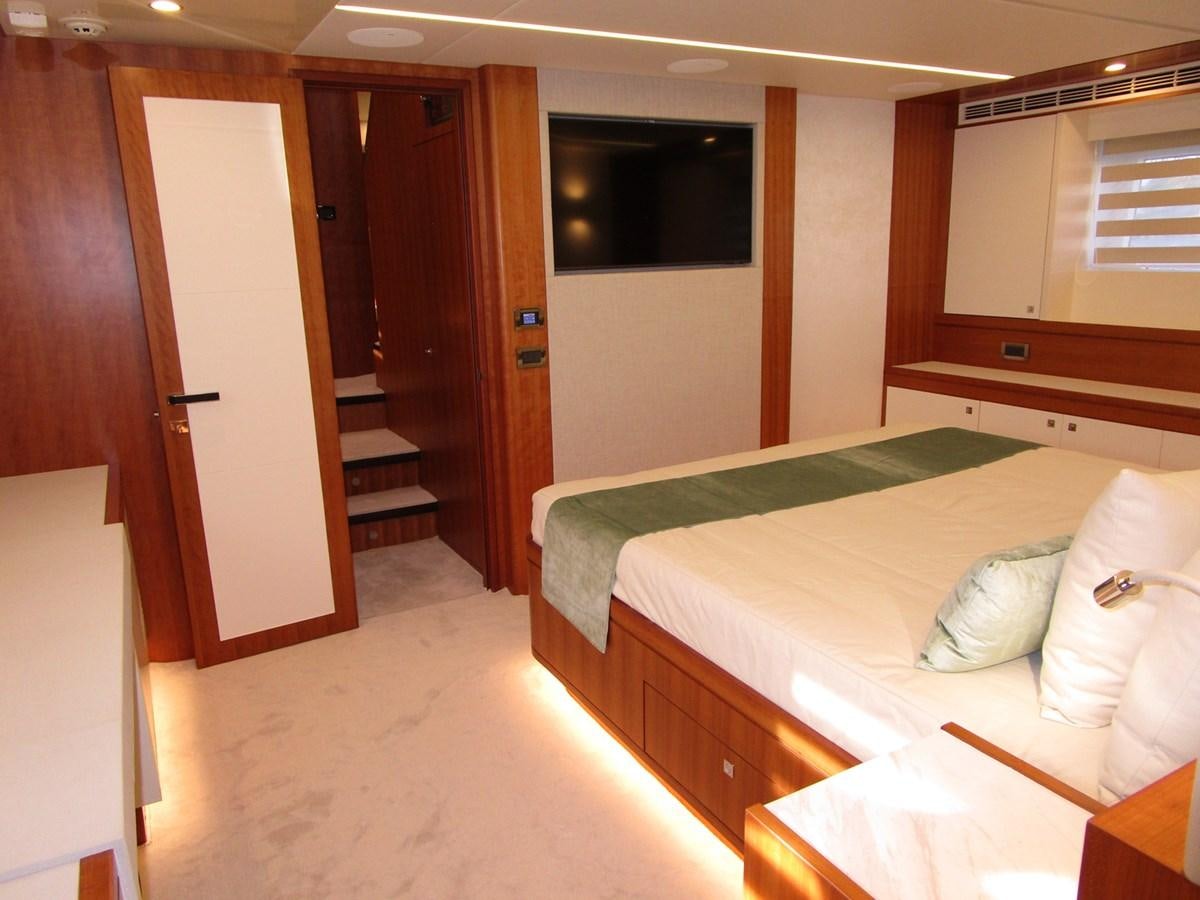 a room with a bed and a door aboard JOHNSON 83 SKYLOUNGE Yacht for Sale