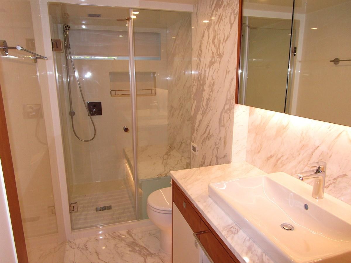 a bathroom with a shower and sink aboard JOHNSON 83 SKYLOUNGE Yacht for Sale