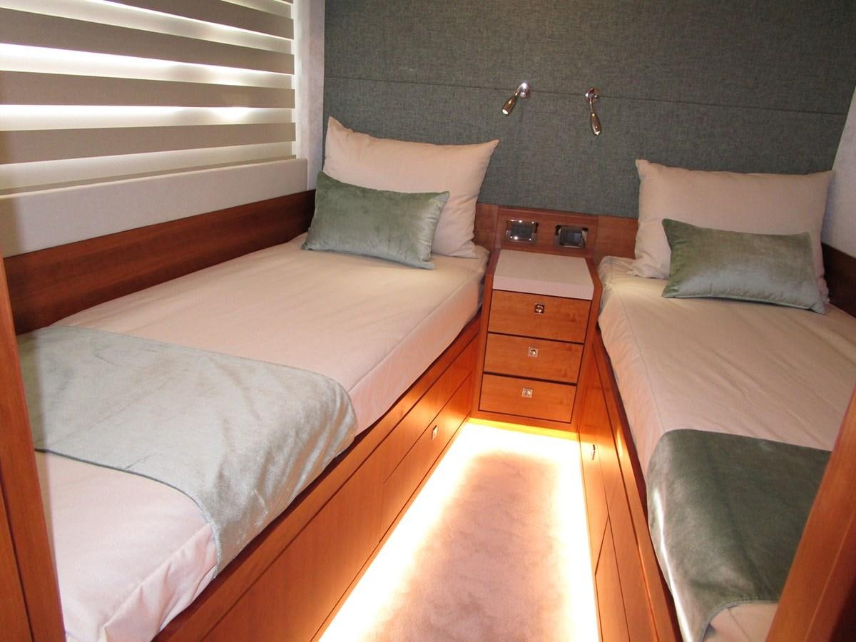 a couple of beds in a room aboard JOHNSON 83 SKYLOUNGE Yacht for Sale